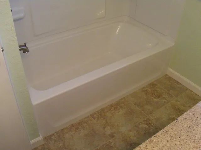 A bathtub is sitting in a bathroom next to a toilet