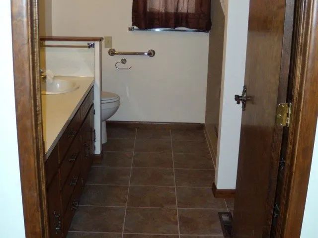 A bathroom with a toilet and a sink in it