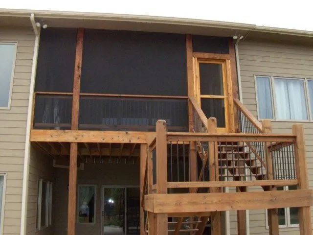 A house with a screened in porch and stairs