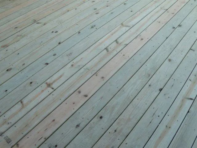 A close up of a wooden deck with a diagonal pattern