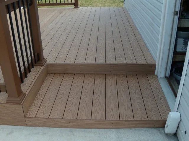 A wooden deck with stairs leading up to it