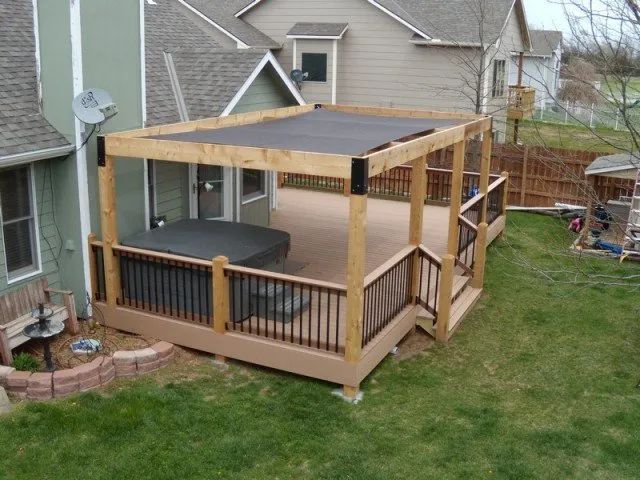 A wooden deck with a hot tub on it