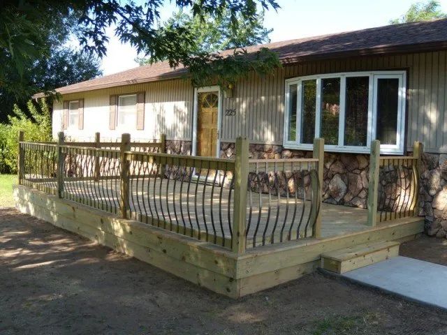 A house with a wooden deck in front of it