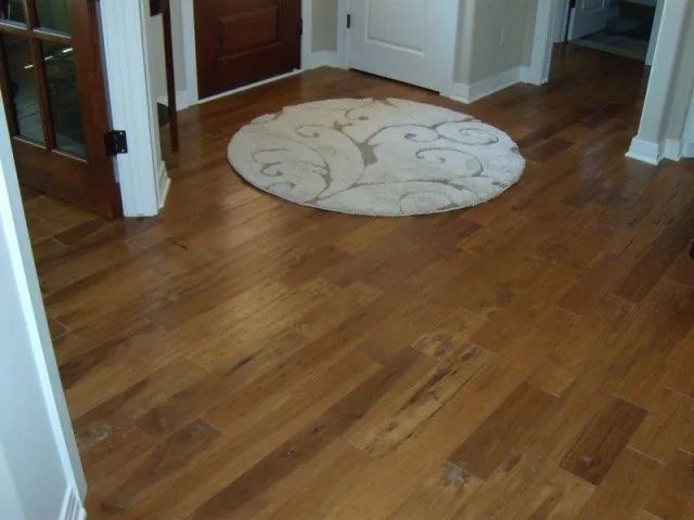 A wooden floor with a round rug on it