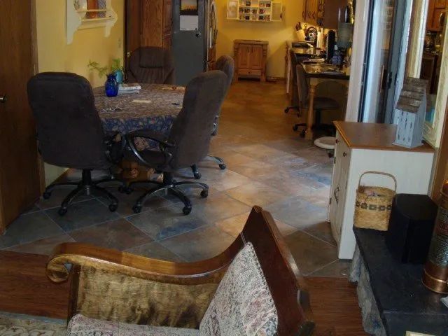 A living room with a table and chairs and a fireplace