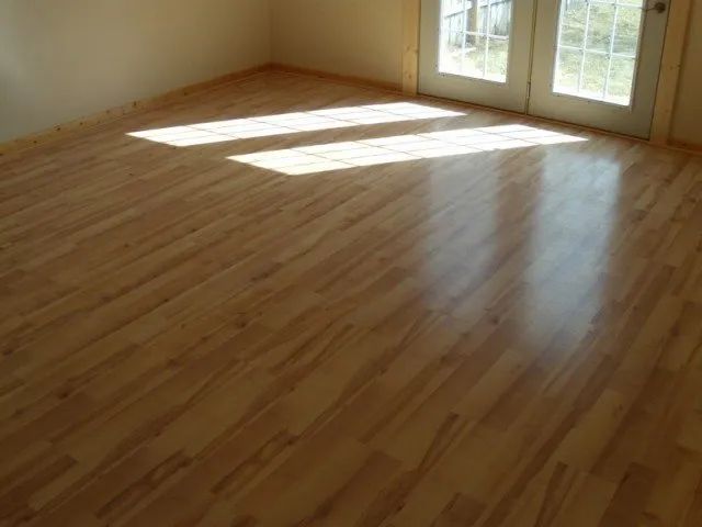 A room with a wooden floor and a sliding glass door