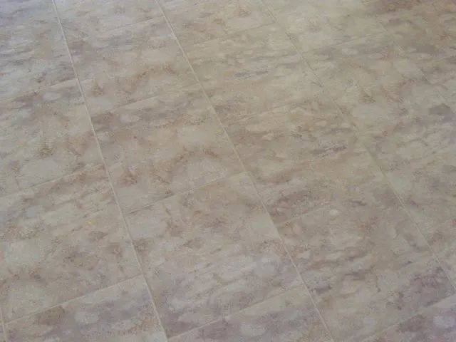 A close up of a tiled floor with a marble pattern