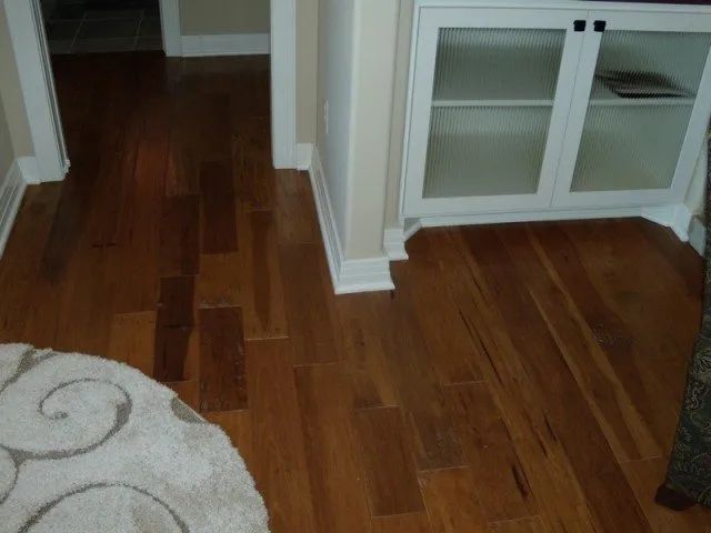 A living room with hardwood floors and a white cabinet