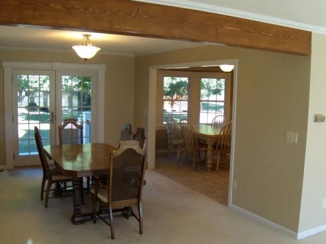 An empty dining room with a table and chairs