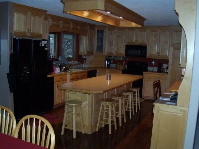 A kitchen with a large island and stools