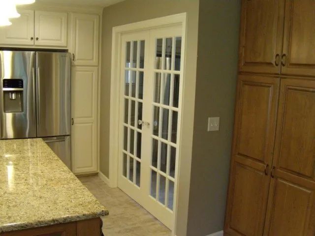 A kitchen with stainless steel appliances and french doors