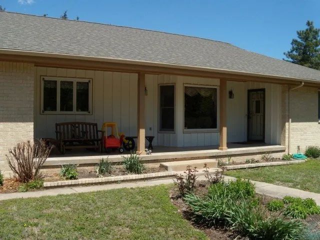 A house with a porch and a bench on it