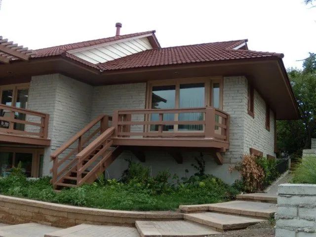 A house with a red roof and stairs leading up to it