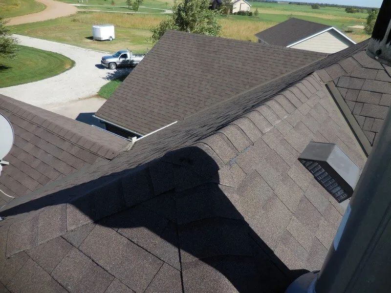 An aerial view of a house with a satellite dish on the roof