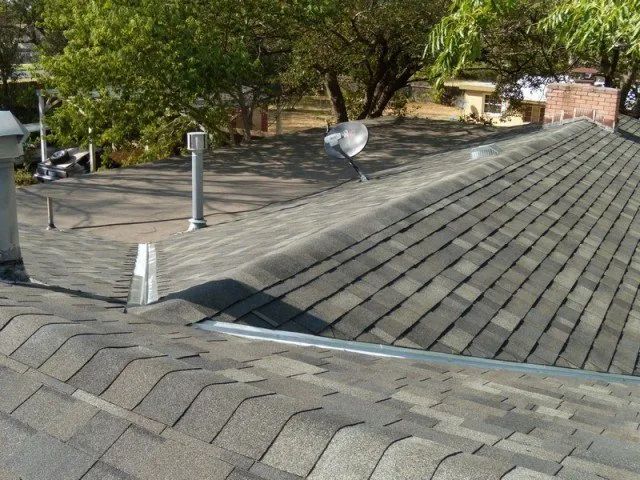 A roof with a satellite dish on top of it