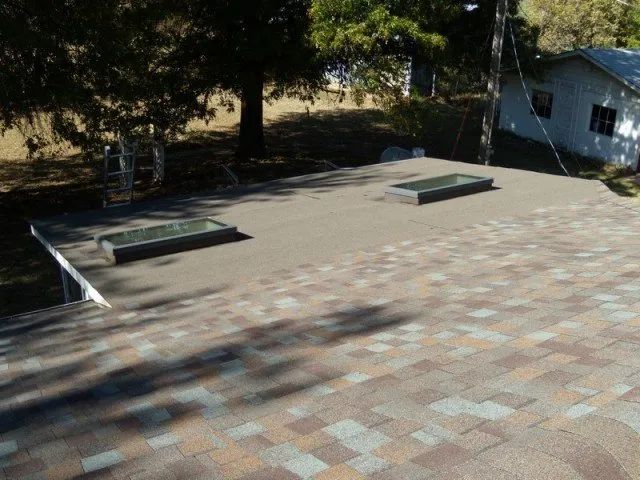 The roof of a house has two skylights on it