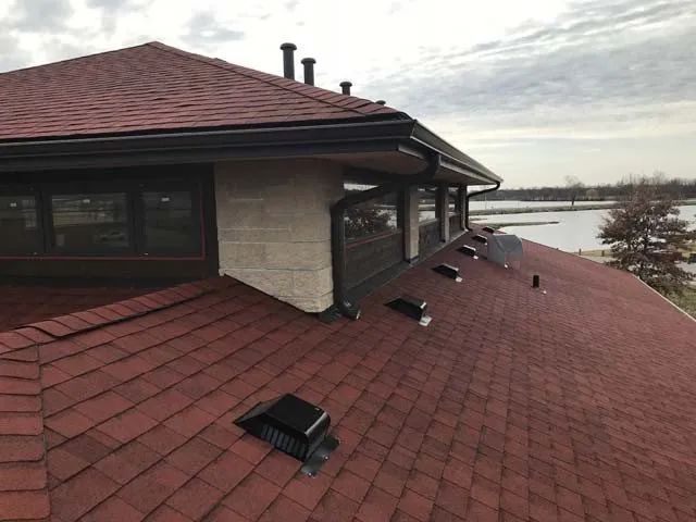 A house with a red roof and a lot of windows