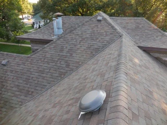 The roof of a house has a vent on it