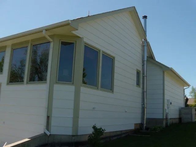 A white house with a chimney on the side