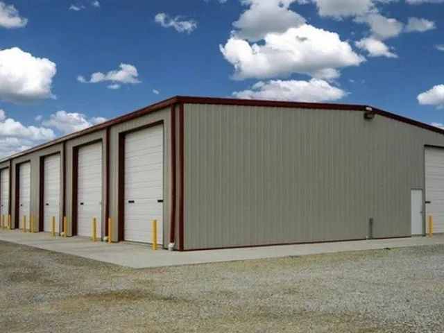 A row of garage doors are lined up on the side of a building