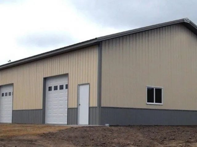 A large building with two garage doors and a window