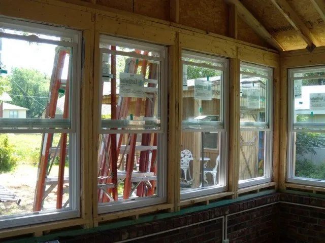 A room with a lot of windows and a ladder