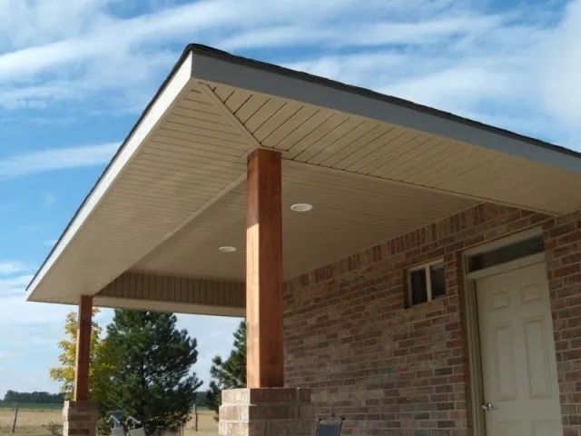 A brick house with a porch and a white door