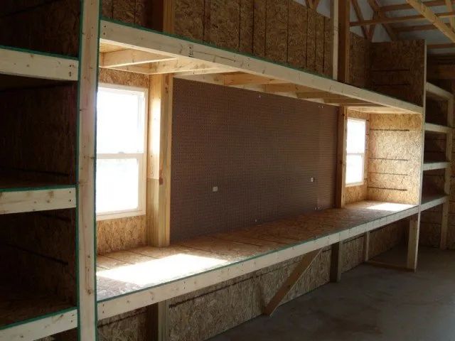 A room with a lot of shelves and a window