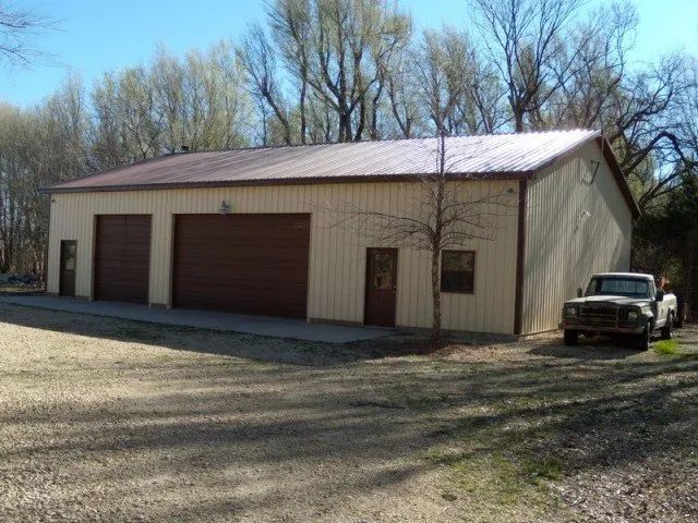 A truck is parked in front of a large building