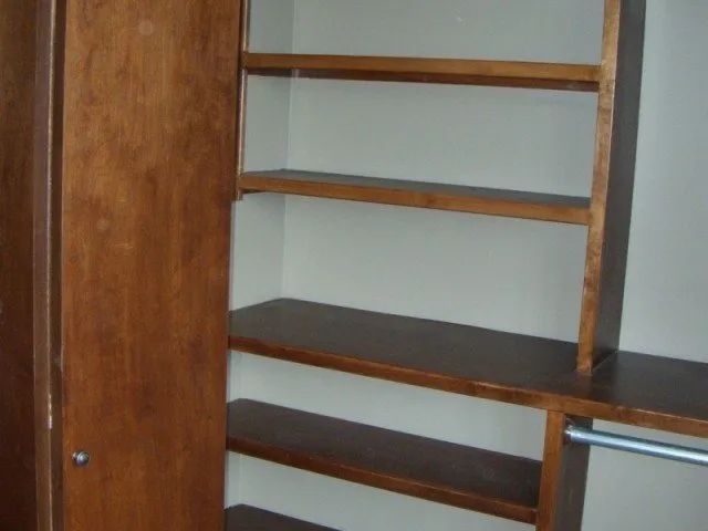 A closet with wooden shelves and a door
