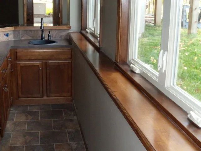 A kitchen with a sink and a lot of windows