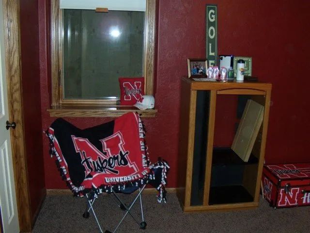 A chair with a blanket that says Nebraska on it