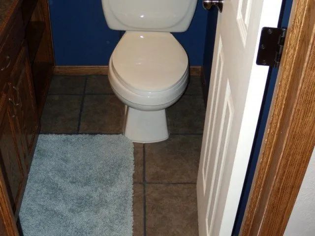 A toilet sits in a bathroom next to a door