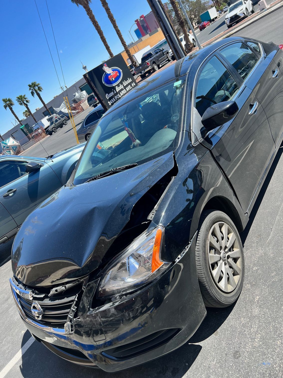 Man repairing car collision damage