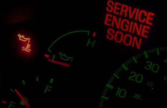 A close up of a service engine soon sign on a dashboard