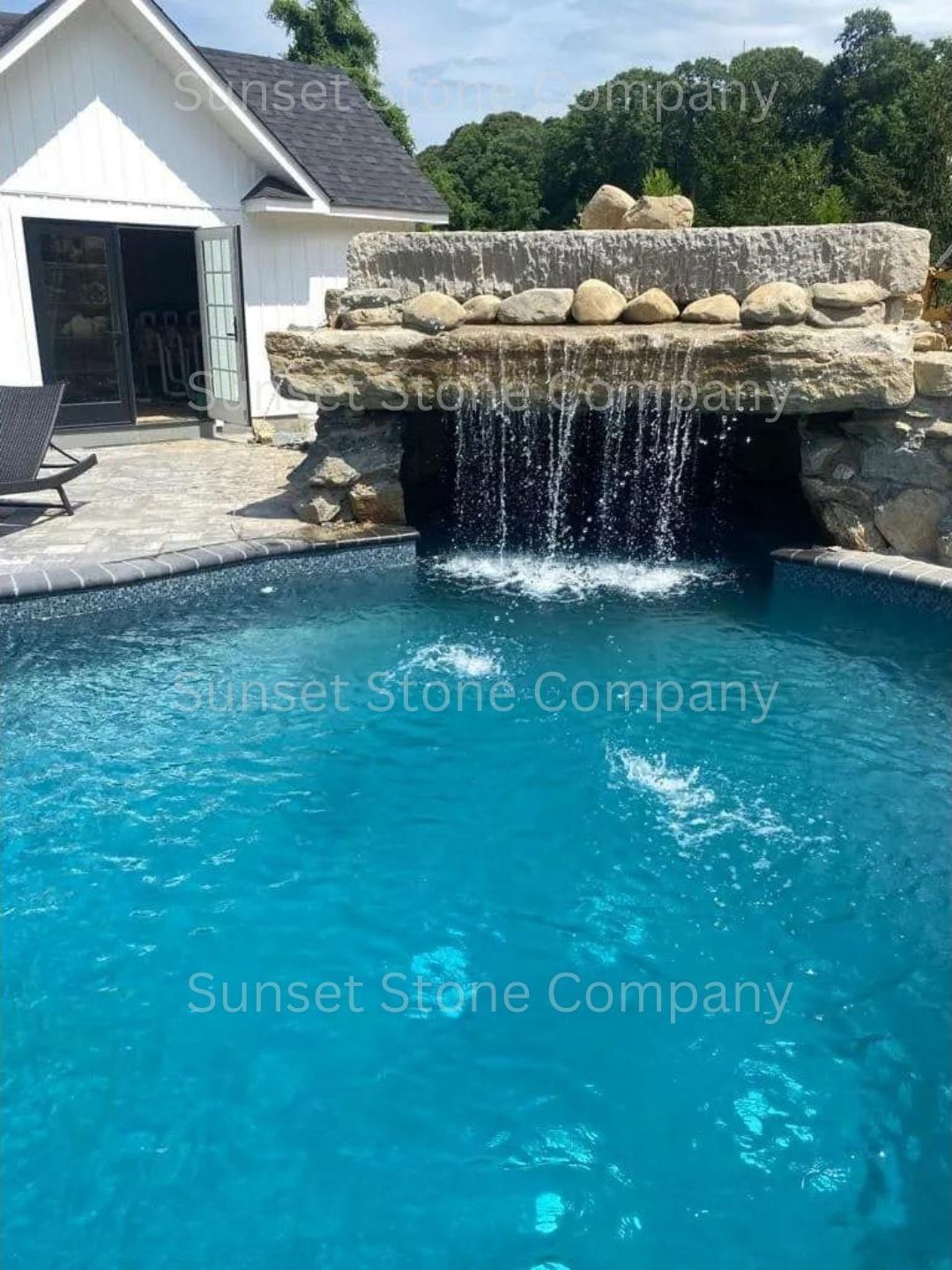 There is a waterfall in the middle of the pool
