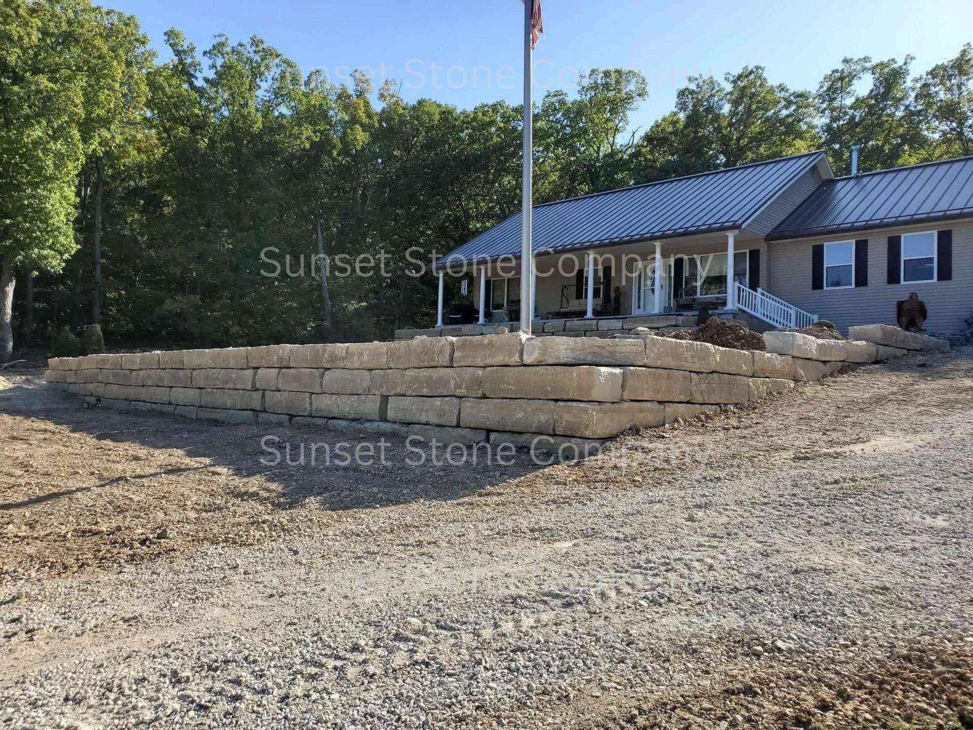 A brick wall is being built in front of a house