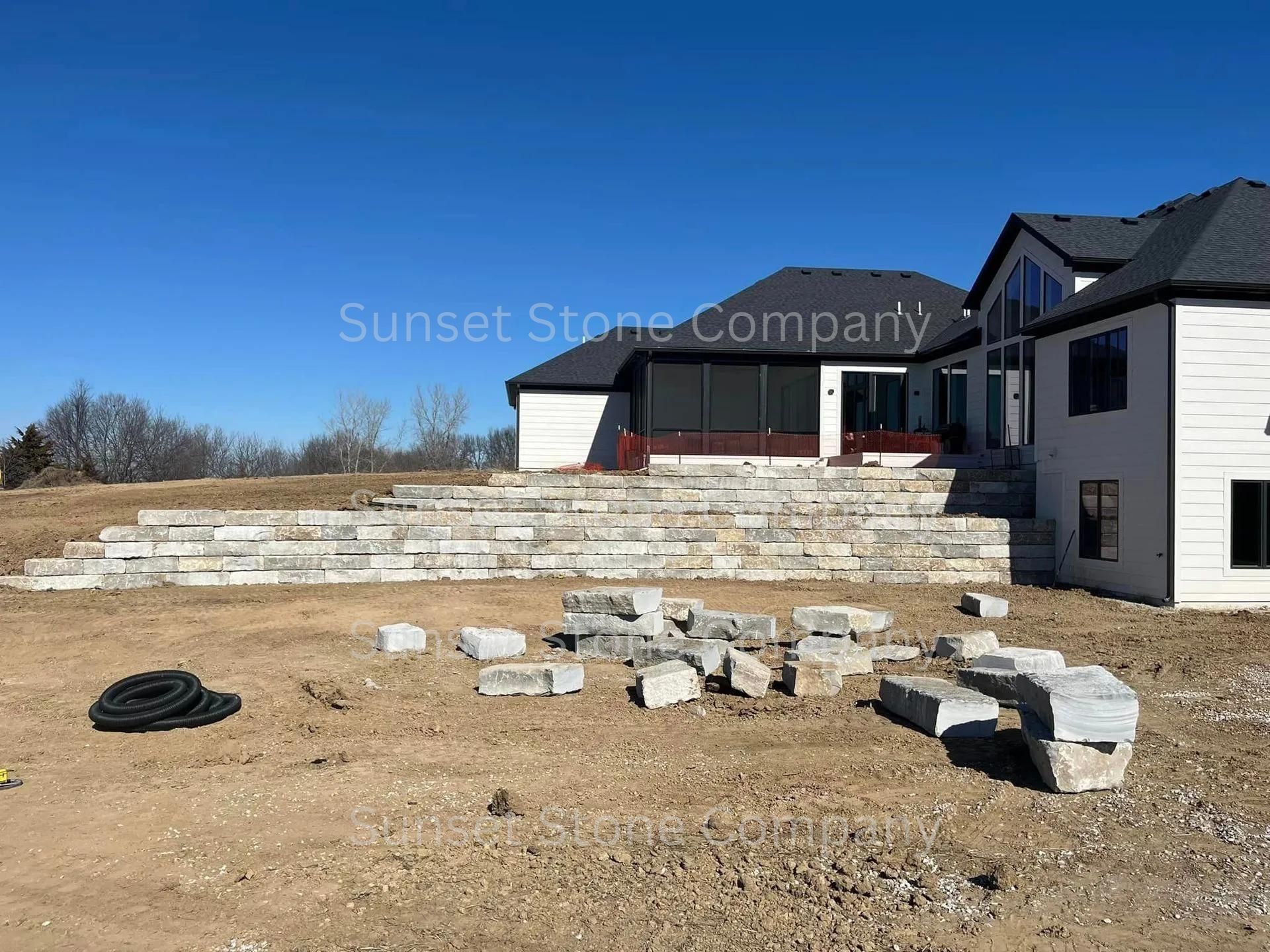 A large house is being built in the middle of a field