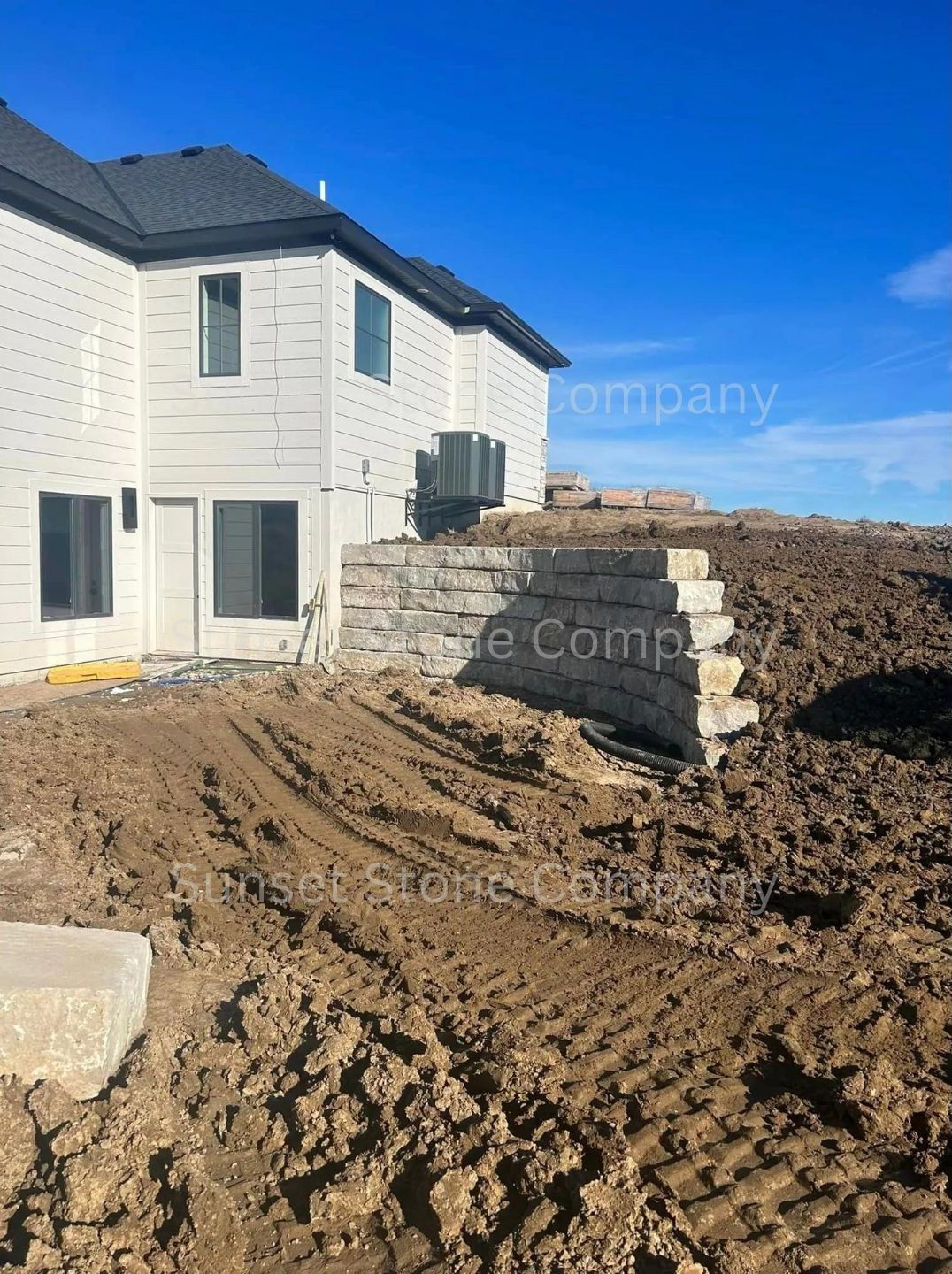 A house is being built in the middle of a dirt field