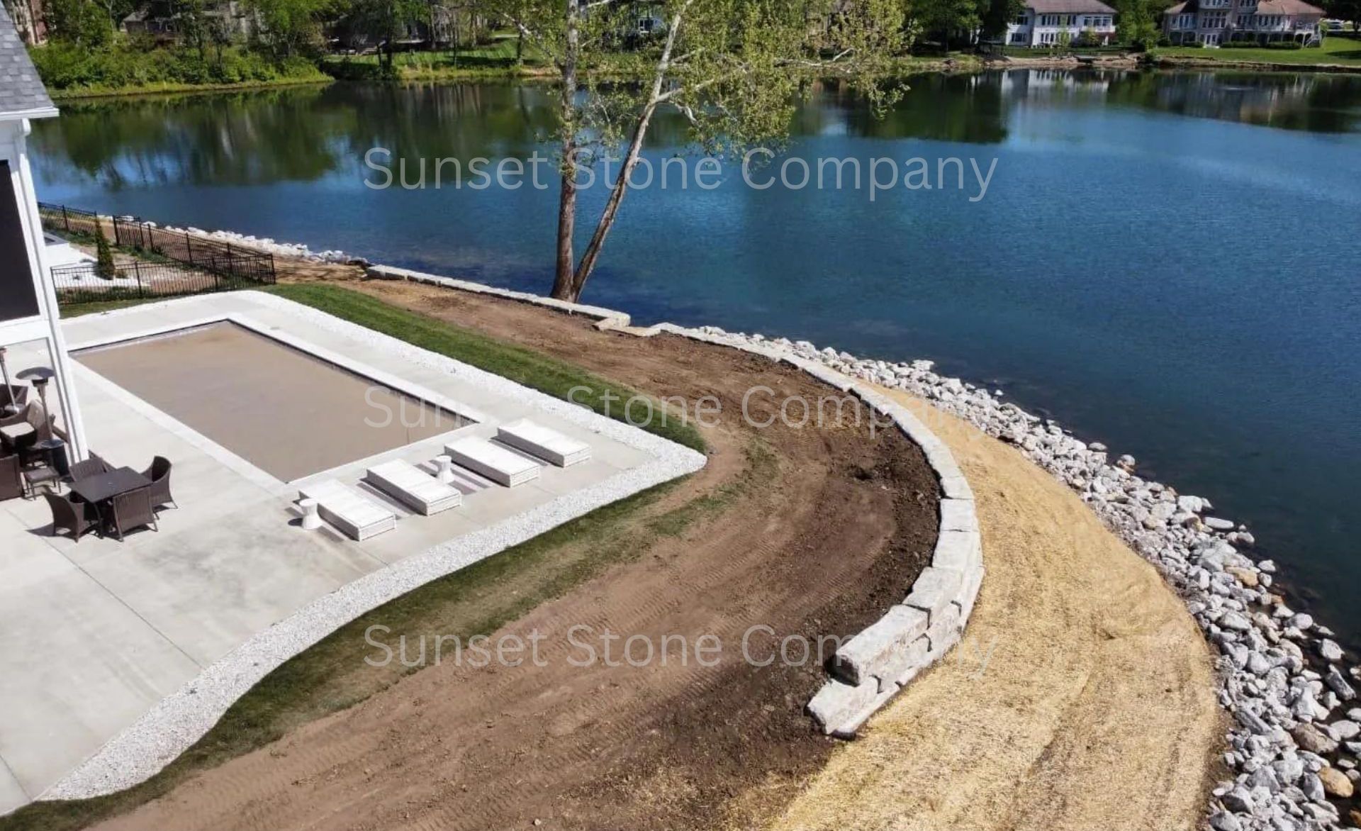 An aerial view of a house next to a lake
