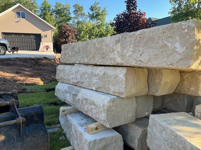 A pile of rocks is sitting in front of a house.