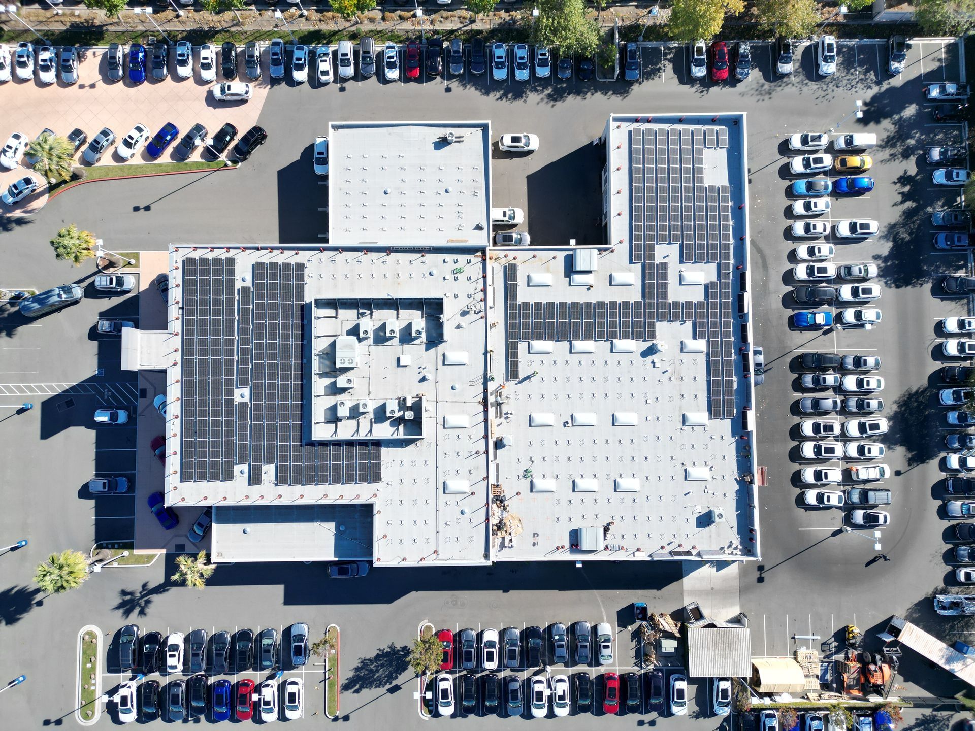 An aerial view of a building with solar panels on the roof