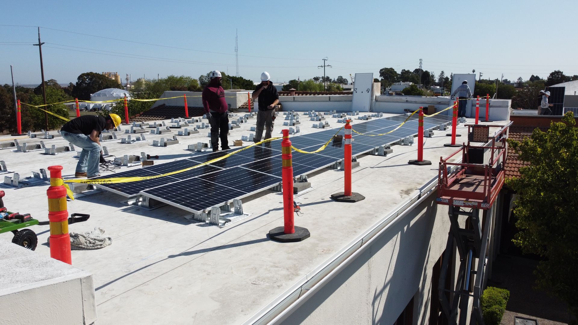 Solar panels are being installed on the roof of a building