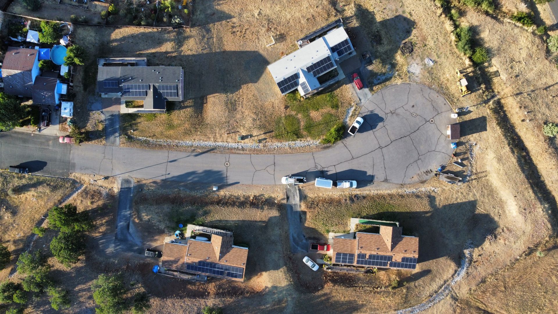 An aerial view of buildings with solar panels on the roof