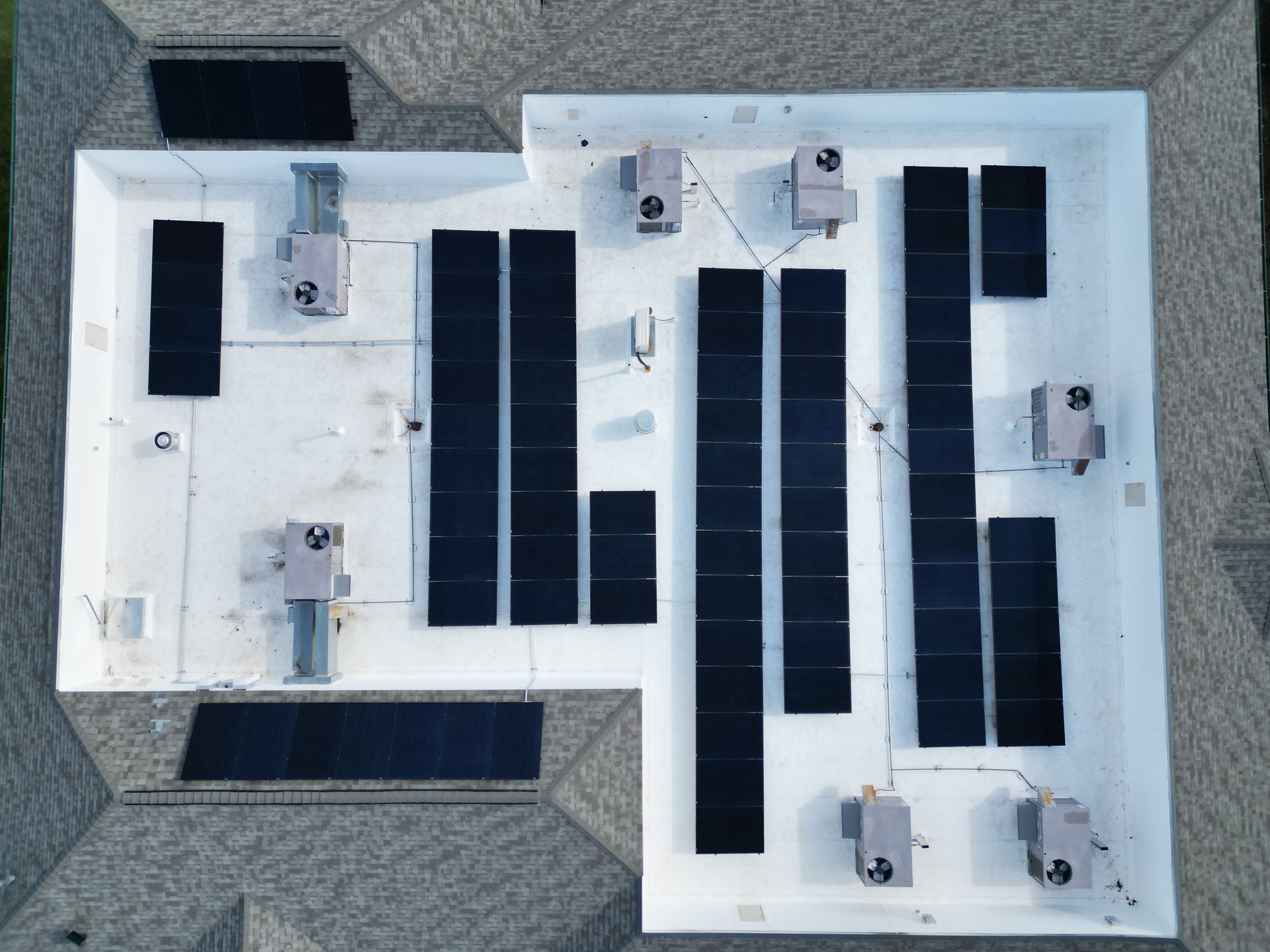 An aerial view of a roof with solar panels on it
