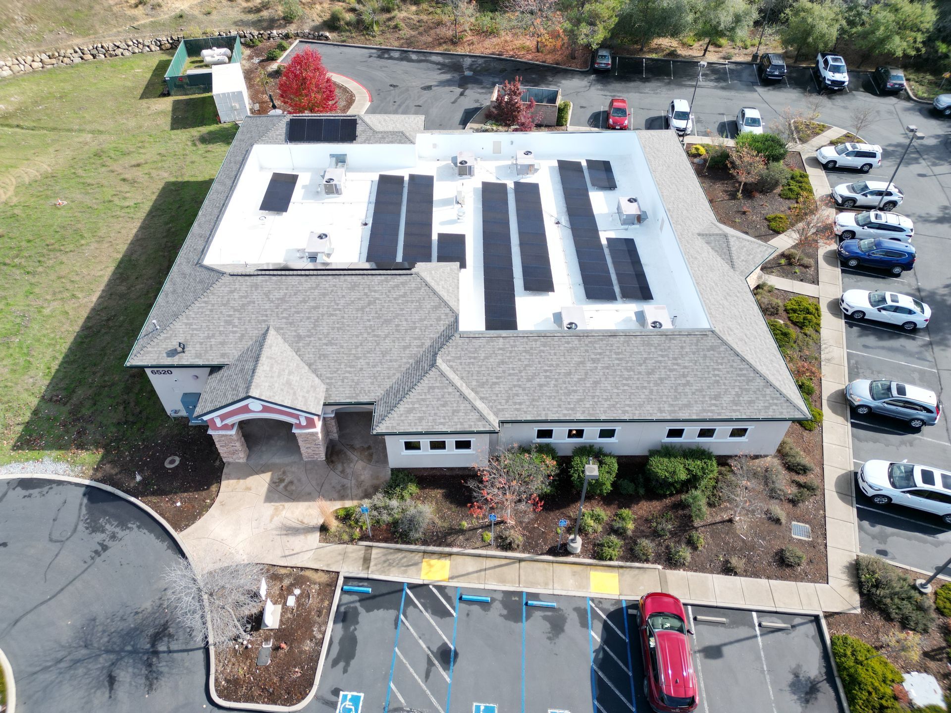 An aerial view of a building with solar panels on the roof.