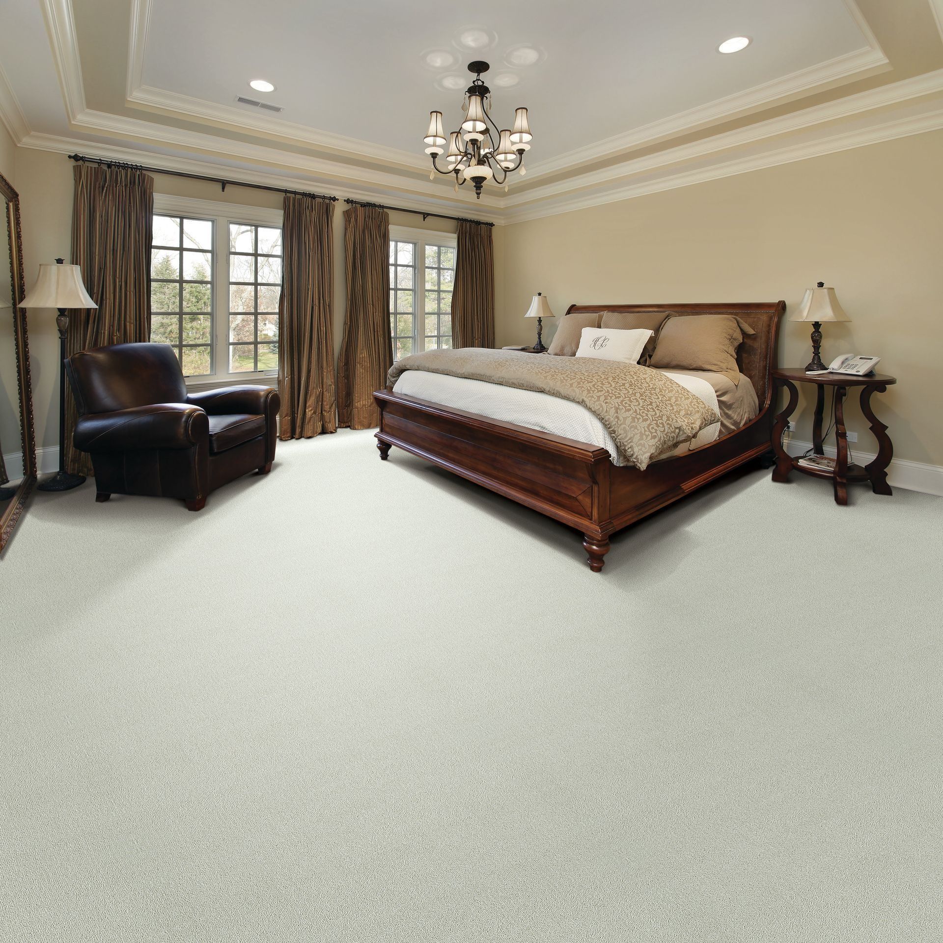 Bedroom with wooden bed, brown armchair, and neutral carpet flooring.