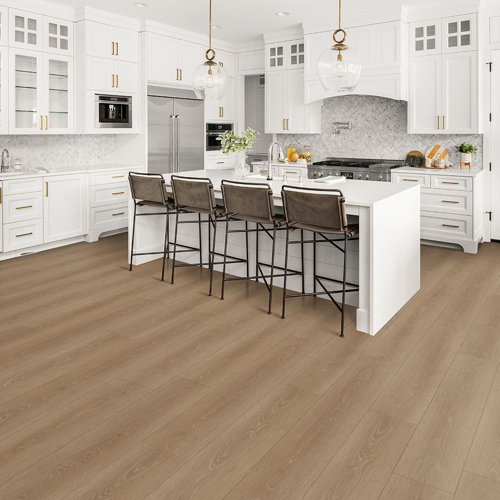 Spacious white kitchen with island seating and light wood-look flooring.