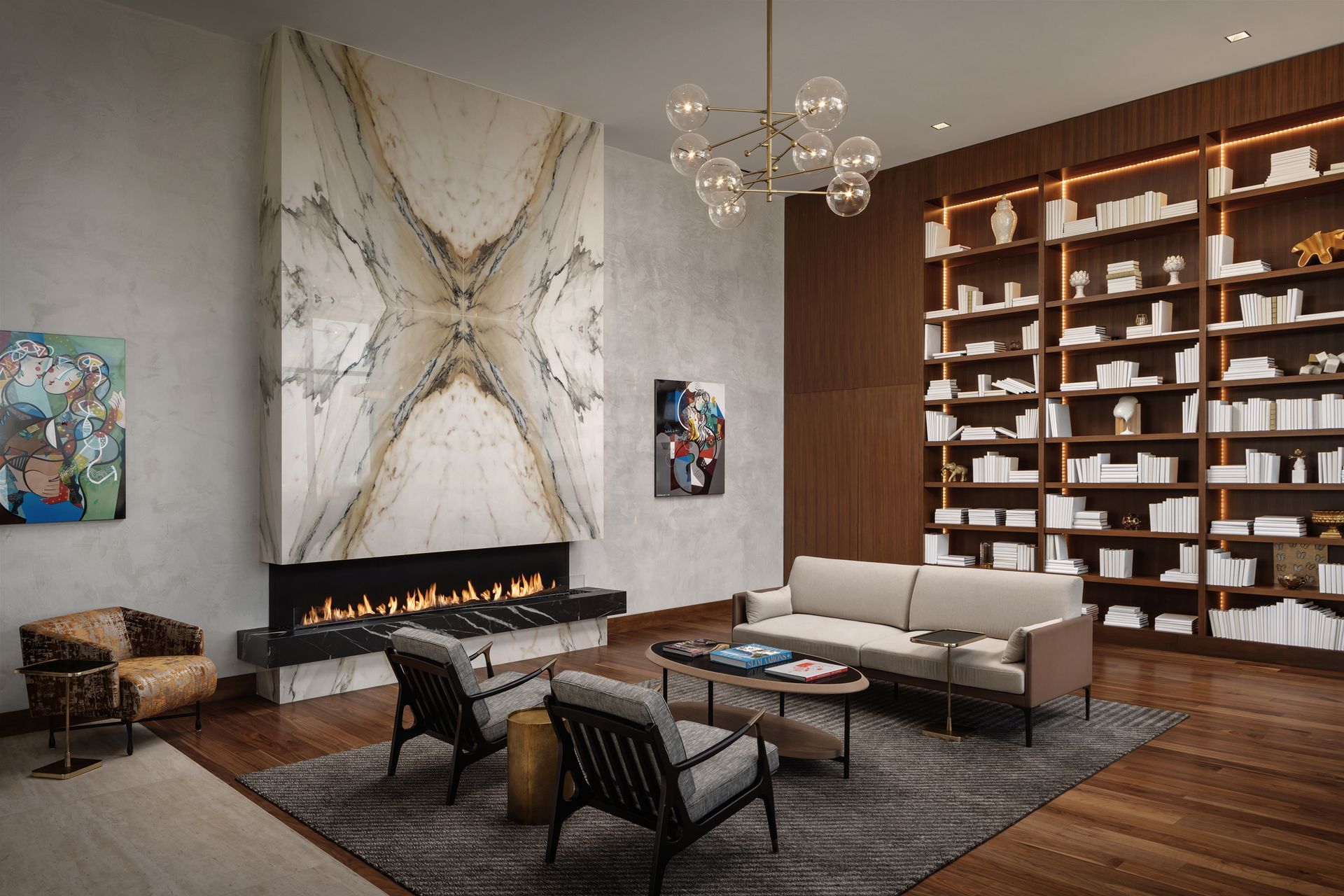 Living room with fireplace, bookshelves, and modern furniture.