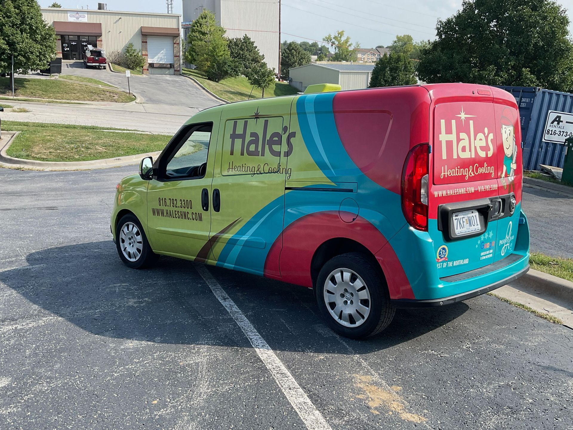 A brightly colored Hale's Heating and Cooling service van parked in an outdoor lot on a sunny day.